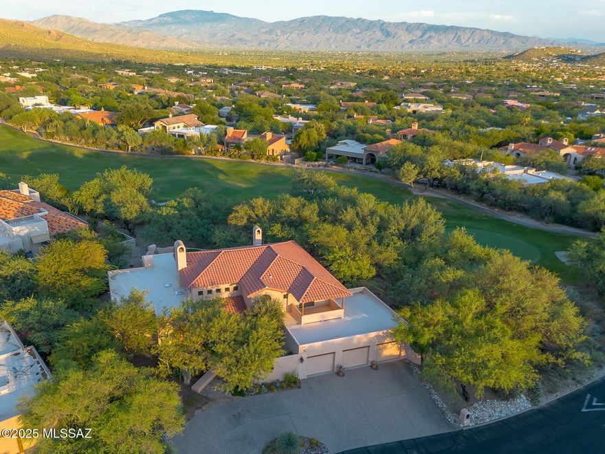 Recent price reduction, Sellers are highly motivated and open to reasonable offers. Situated in prestigious Ventana Canyon Estates, this exceptional Mike Wachs Southwestern Style Home overlooks hole #7 of the Canyon Golf Course. This fantastic masonry/stucco home features 4090 sf, 3BR/4BA/Den, private, corner lot, high, beamed ceilings and beautiful back yard with pool, spa, fountain, fireplace and golf course views.
Entering through the courtyard gates and entry door to the open foyer, exposes hand crafted beams, Saltillo tile floor and custom cabinetry.  The large living room is immediately evident, complete with the large, custom fireplace and view of the phenomenal back yard. A large dining area and wet bar complete this area and make entertaining a breeze. The superb chef's kitchen features a large island with electric cooktop, dbl ovens and ample cabinetry. The kitchen is flanked by a generous sized family room with fireplace and breakfast nook.  A large laundry room is on the other side of the kitchen, with access to the massive, three car garage just beyond. The split bedroom plan allows the Primary Suite to be in a world of its own. Contained within this suite is the bedroom, sitting area with dual side fireplace, patio access and Primary bathroom. A generously sized den sits outside the Primary Suite, complimented by the powder room just across the hall. The guest wing features two large bedrooms, each with their own en-suite bathrooms and walk in closets. Additional features include Pella windows and doors, built in vacuum and abundant storage. This desert hacienda is a must-see for anyone looking for the privacy of a large property, coupled with the golf course and mountain views in a gated, country club setting.