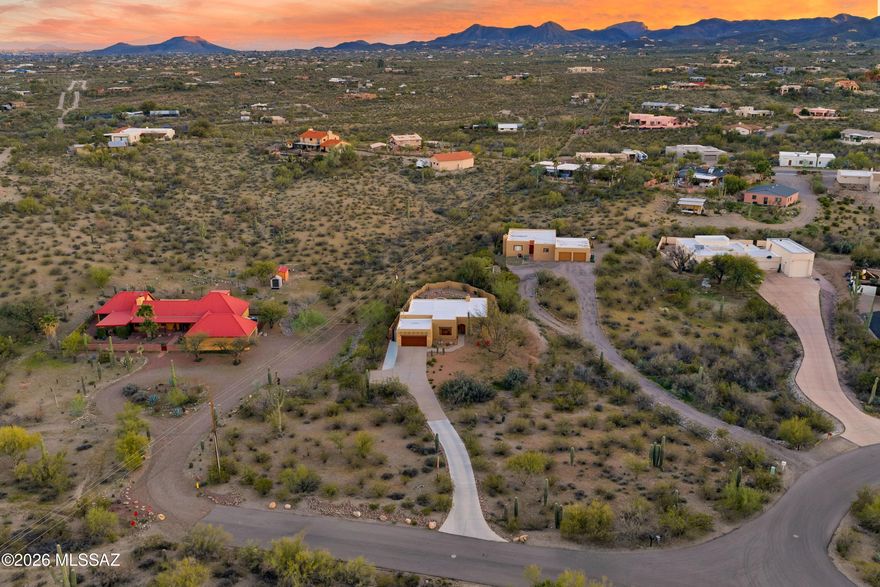 A quintessential Southwestern home meets an artful touch amidst the beautiful desert landscape in the Tucson Mountains. While this property feels away from it all, there is easy access to both top notch trail systems and city life - the perfect blend of lifestyles. Situated on a 1-acre lot at the end of street, the home has been tucked away. Saguaros and desert foliage line the drive and create a cocoon of greenery. An incredibly private and serene setting is found both indoors and out. Inside the 1,850 sq ft home, there are 3 bedrooms, 2 full baths well situated over a split floor plan with excellent storage. Large windows throughout invite the eye outdoors, a scene that is ever changing as light moves during the day. Wood floors and Saltillo tile are complemented by light paint and fun splashes of color found in accent walls and countertops. Warm and inviting, the gas fireplace anchors the main living space. The charm here is undeniable.

Dual outdoor spaces provide the opportunity to live outdoors in a variety of fashions. The north facing front yard creates natural seating areas amidst the trees with views of the Catalina and Tucson Mountains. The south facing backyard has been finished for lounging and entertaining.  A generous covered patio with ample seating leads to the pool and spa, all with views of the surrounding hillside and birds flying overhead. A peaceful and quiet environment.

An outdoor lifestyle is at your fingertips here in the Tucson Mountains. Under 2 miles away sits access to Sweetwater Preserve, an extensive trail system for hiking, mountain biking and horseback riding, as well as access to The Loop multi-use path for road cycling or running. Under 4 miles away you will find the El Camino Del Cerro Trailhead, which provides hiking trails entering incredible setting of Saguaro National Park West. All of this, while only 15 minutes to Downtown Tucson and 20 minutes to the University of Arizona.