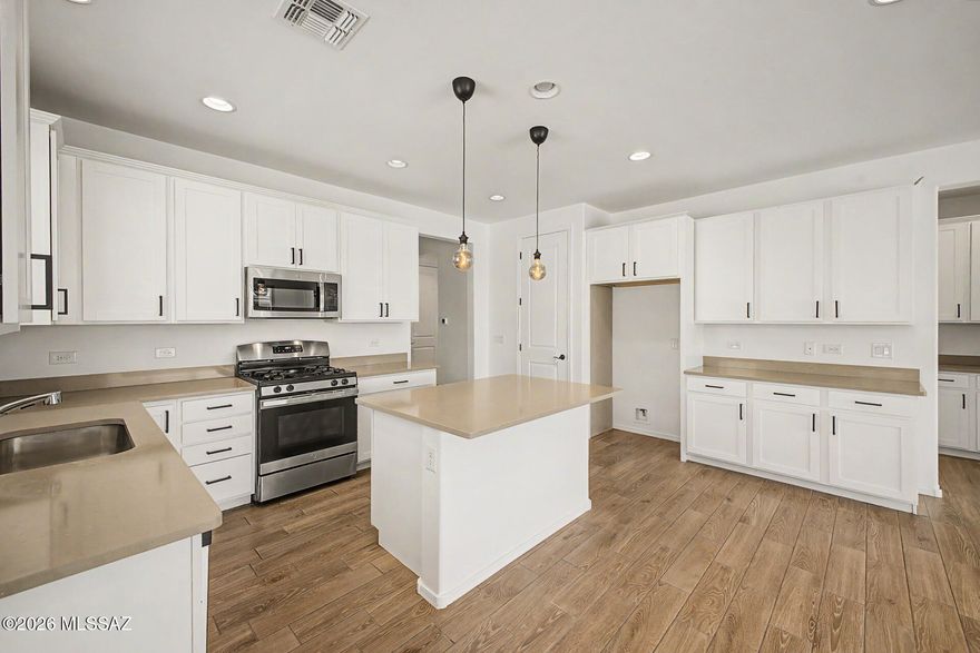 Beautiful Ranch-style home in Gladden Farms is on the market & ready to move in! Upon arrival, discover a great curb appeal paired with easy care landscaping. The interior boasts a fresh paint job, functional open layout with tall ceilings, and wood-like tile flooring. The kitchen is equipped with shaker cabinets, solid surface countertops, and stainless steel appliances. Great size for entertaining! The sliding glass doors allow an easy transition for indoor-outdoor living. The main bedroom features plush carpet, a pristine ensuite bathroom with dual sinks, and a walk-in closet. The house is located within walking distance from the community park/playground, and is close to the Paws 'n Claws Park and the Dinosaur play Gladden Farms. This is the home you've been looking for. Act now!