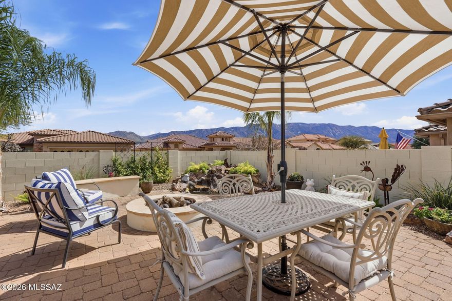 Enjoy stunning Catalina Mountain views from this Silverton model in SaddleBrooke's active adult community. This 3BR/2BA, 2,199 SF home features great curb appeal with charming front paver courtyard. Inside, living and dining rooms offer ideal entertaining space, while the family room with gas fireplace opens to the patio. The custom chef's kitchen boasts white maple and hand-rubbed cherry cabinets, granite counters, stainless appliances, Wolf oven, and gas cooktop. The owner's suite includes a French door to the patio, updated bath, and expanded walk-in closet. Guest wing with 2 bedrooms and bath. Ceramic tile throughout. Outdoor living shines with a large covered paver patio, firepit, BBQ, water feature, and mountain views. 2.5-car garage tops it off. Move-in ready!