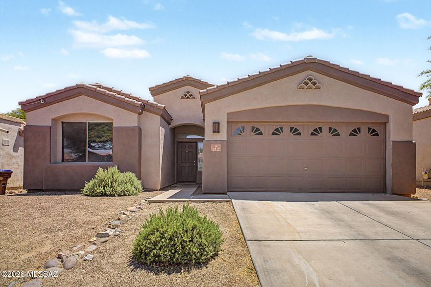 ***Assumable VA Loan at 3.125%*** Welcome to this beautifully maintained 3-bedroom, 2-bathroom single-family home located in a gated community within the highly desirable Rancho Sahuarita. Built in 2003, this spacious 1,776 sq ft residence offers comfort, functionality, and modern touches throughout.

Step inside to discover soaring high ceilings and an open-concept layout that creates a bright and inviting atmosphere. The great room features a cozy gas fireplace--perfect for relaxing evenings or entertaining guests. The spacious kitchen is includes granite countertops, a center island, stainless steel appliances, and a gas range, offering plenty of room for cooking and gathering. The expansive primary suite provides a peaceful retreat with ample space and a luxurious ensuite bathroom featuring dual vanity sinks, a separate soaking tub and walk-in shower, and not one, but two walk-in closets. Two additional bedrooms offer flexibility for family, guests, or a home office.

Additional highlights include a 2-car garage and a washer and dryer included for added convenience.

Enjoy all the amenities that Rancho Sahuarita has to offer--a vibrant master-planned community with multiple pools, scenic parks, walking trails, a beautiful lake, and a full recreation center, and so much more.

This home combines comfort, style, and access to an incredible community--don't miss the opportunity to make it yours!