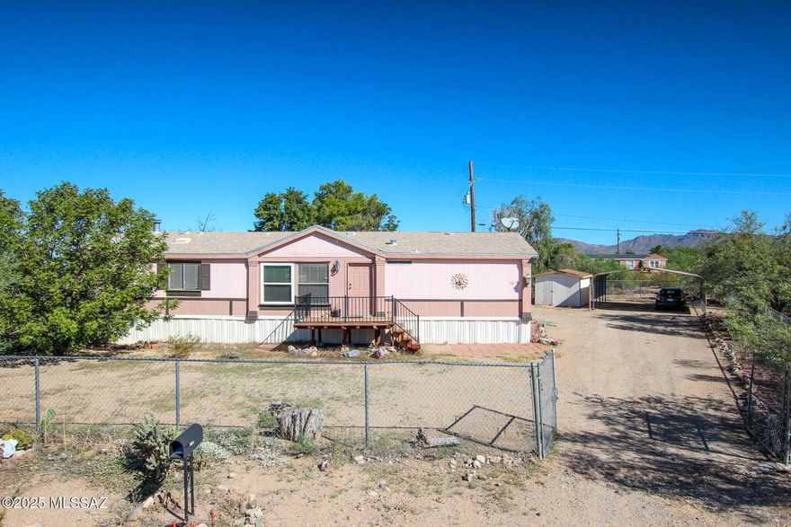 Don't miss this beautifully maintained 3BR/2BA home in Tucson! Split floor plan offers privacy, with spacious living room and cozy family room featuring a natural fireplace. Located at the end of a quiet road backing to state land for added privacy and views. Fully fenced, landscaped lot with mature trees, 10x38 covered patio, 2-car carport & room for RVs or toys. No HOA!
