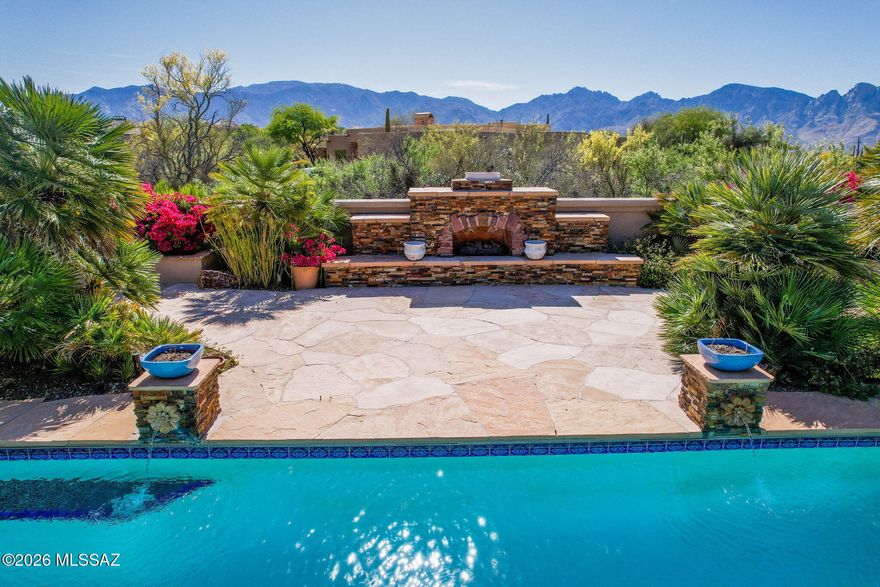 Luxury living at its finest. This property sits back from the street and allows significant privacy on it's over 1 acre parcel. The neighborhood is guard-gated for additional security and exclusivity. In the rear of the home you will find a pool, spa, top of the line outdoor kitchen, a fireplace, and incomparable views of Pusch Ridge. Inside, this home boasts two large family areas, two dining areas,and a split design for guests. High ceilings make this over 4300 sq ft home feel even more grand. For wine lovers, a wine room is off the kitchen. The oversized 3 car garage as well as ample closet space ensure that there is room for everything you own. A turf covered dog run ensures no member of the family was not considered. This home has everything you could want and more.