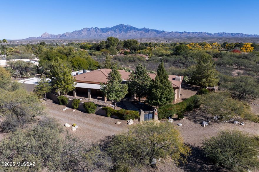 Welcome to this impeccably maintained home located in the beautiful and tranquil Tubac Country Club Estates. From the moment you arrive, you are greeted by a charming gated courtyard and welcoming entryway that set the tone for the comfort and quality found throughout the home.

Step inside to an open and spacious living room featuring high ceilings with striking overhead beams, recessed lighting, and large neutral tile floors that create a bright and airy atmosphere. A cozy fireplace anchors the space, while a sunken bar adds a perfect spot for entertaining and gathering with friends and family.

SEE MORE.. The open kitchen is both functional and inviting, highlighted by a large picture window over the sink that frames serene views of the patio and surrounding mountains, allowing natural light and nature to flow in. The kitchen boasts gorgeous granite countertops, a large butcher block island ideal for meal prep or casual dining, and a generous pantry providing ample storage. Adjacent to the kitchen, the dining area sits comfortably between the kitchen and great room, accented by a beautiful chandelier and offering an ideal space to enjoy everyday meals or special occasions.

Throughout the home, tasteful Southwestern touches add warmth and character, including colorful tiled bathrooms that bring charm and personality to the living spaces. Every area of the home reflects pride of ownership and thoughtful care, showcasing its impeccable maintenance.

The private, fully enclosed backyard is a true retreat. With mountain views and peaceful surroundings, it offers a beautiful setting to relax, entertain, or simply enjoy the outdoor lifestyle Arizona is known for. Whether sipping your morning coffee or enjoying an evening under the stars, this space provides serenity and privacy.

Car enthusiasts and hobbyists will appreciate the expansive 7-car garage, offering abundant room for vehicles, storage, and toys alike.

This exceptional home combines comfort, style, and functionality in one of Tubac's most desirable and quiet neighborhoods. Experience Arizona living at its best in a residence that has been lovingly cared for and is ready to welcome its next owner.