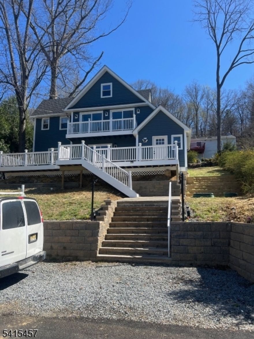 Perched high above Lake Mohawk on coveted Birch Parkway, this nearly new home enjoys sweeping lake views from one of the most desirable vantage points in the community.  From its elevated position across from the shoreline, the home captures panoramic views of the water while offering a sense of privacy rarely found so close to the lake.  Birch Parkway is widely considered one of the most sought-after addresses in Lake Mohawk, known for its dramatic lake views and proximity to the shoreline. Recently completed construction includes major system upgrades such as a new septic system, new HVAC with central air and heat, tankless water heater, updated flooring, renovated kitchen and modern bathrooms. The home carries a Sparta mailing address but is physically located in Byram Township, a unique distinction along this section of Birch Parkway where homes share membership in the Lake Mohawk community.The setting allows residents to fully enjoy the lifestyle that makes Lake Mohawk one of northern New Jersey's most distinctive lake communities, including access to private beaches, boating, fishing, community events, and the option to join the historic Lake Mohawk Country Club for golf, tennis, dining, and social activities.Homes with this combination of elevated lake views, modern construction, and location on Birch Parkway rarely become available.