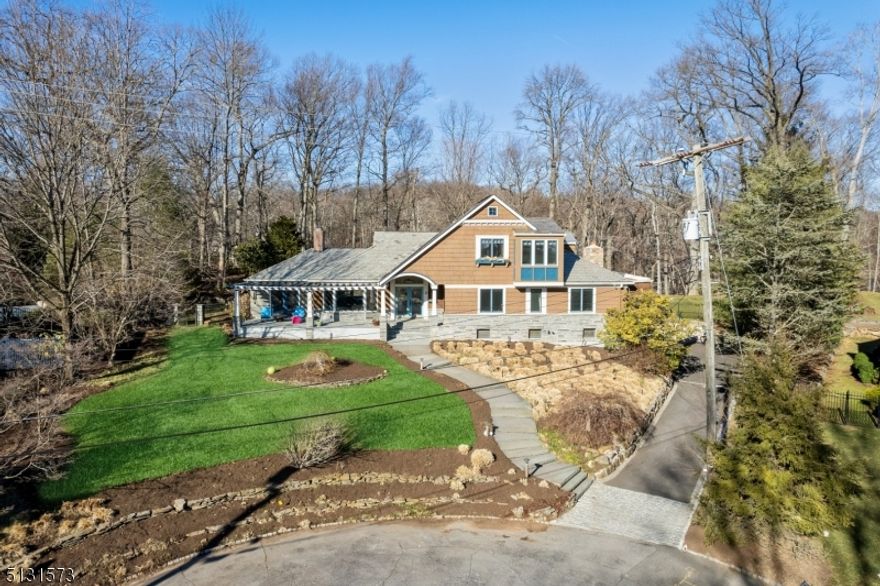 Spectacular Short Hills show stopper! Architectural details, sophistication and natural beauty abound in this magical custom mid-century modern home. Perched majestically at the end of a quiet cul de sac and backing to the South Mountain Reservation, this Deerfield section home features multiple outdoor entertaining spaces including a stunning gunite pool, outdoor fireplace, level yard with extensive hardscaping and mature plantings. Formal Living Room is front-to-back and boasts three exposures, statement gas fireplace and is an open concept to the Den with a vaulted ceiling, stone gas fireplace and french doors with direct access to the front patio with stunning sunset views. True entertainers eat-in Chef's Kitchen boasts custom wood cabinetry,  granite countertops, and large island. Great Room with vaulted ceiling, wood burning fireplace and direct access to the rear patios. 3 en-suite Bedrooms plus an updated Powder Room complete the first level.  Sumptuous Primary Wing on the 2nd level features walk-in closet with built-ins. Spa-like Bathroom with oversized glass enclosed shower, jetted soaking tub, dual sinks and separate commode area plus an additional loft / library area with an office. Massive finished lower level with Recreation Room, Home Theater with tiered seating and surround sound, Laundry Room, 5th bedroom and full bathroom as well as a Mudroom area with direct access to the oversized attached 3-car garage. Enjoy your private oasis for years to come!