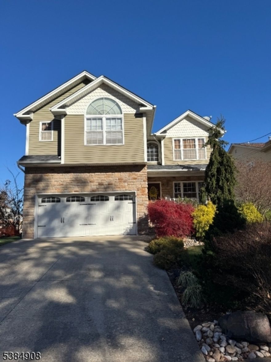 Welcome to this spacious and well-maintained Colonial offering 4 bedrooms, 2.5 bathrooms, and a 2-car garage equipped with water and heat located in the desirable Sunnyside section. Featuring hardwood floors and 8 ft ceilings throughout, this home was designed with an extensive list of quality construction upgrades for lasting comfort and style. Enjoy cooking and entertaining in the large eat-in kitchen with pantry and large deck perfect for meals or gatherings. The home also includes a full basement featuring high ceilings, providing both ample storage and room for expansion. Conveniently located near public transportation, shopping, and schools, this property blends charm with modern amenities. Don't miss the opportunity to make this beautiful property your new home! Can accommodate a quick closing!