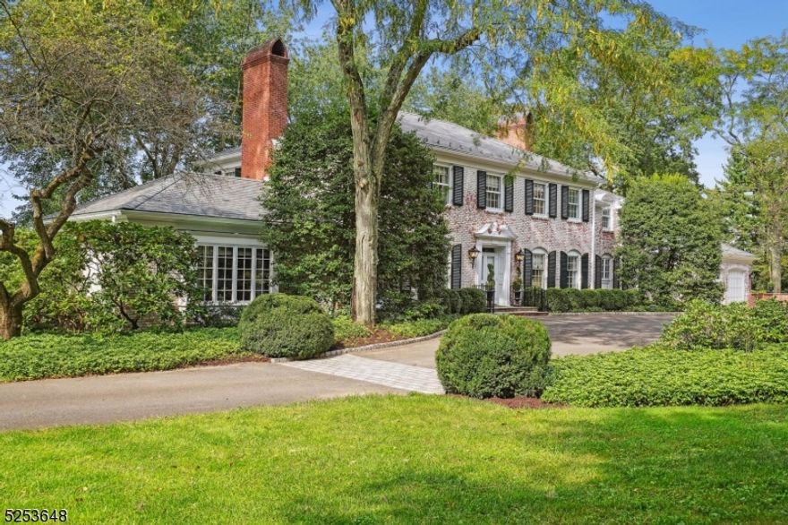 Welcome to Wyndfield, an extraordinary James Timpson colonial being offered to the public for the first time. Timeless in its design, the home features a floor plan perfectly suited for entertaining & daily living. The foyer opens to a graceful Helical staircase, a grand formal LR with gas fireplace & stunning DR with French doors opening to a bluestone patio. Beyond the LR is a paneled library with wet bar, wood-burning fireplace & French doors leading to the patio. The main level is completed by a spacious gourmet kitchen & adjacent family room, breakfast room, 2 powder rooms & mudroom. Each room on this level opens to the patio, providing abundant natural light & an ideal indoor/outdoor setting. The 2nd level contains 4 generously sized bedrooms, including the primary suite with dressing room & luxurious bath with onyx marble flooring. Three other bedrooms & 2 newly renovated baths, one of which is ensuite, are also found on this level. Renovated lower level features a large rec room, laundry room & wine storage. Exceptional millwork, sophisticated architectural elements & superior finishes bear witness to an uncompromising commitment to quality. Outside, the expansive bluestone patio overlooks a sweeping lawn, a parterre boxwood garden & potting shed. Eight lush acres, 6.5 of which are farm assessed, include a vineyard & apple orchard, with 56 preserved acres bordering the property. All of this in a prime New Vernon location, with convenient access to transportation.