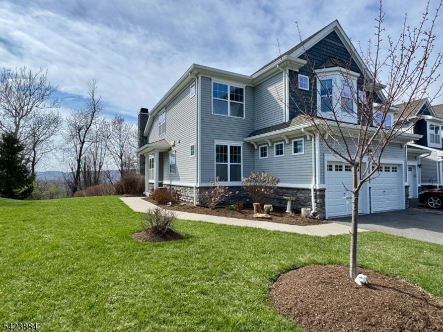 Are you looking for the safety and low maintenance of community living without sacrificing other priorities? YOU HAVE FOUND IT! Welcome home to this light, bright and spacious three bedroom townhome in the beautiful gated community of Panther Valley. This very well maintained "Sherwood" END UNIT is backed by woods and enjoys distant mountain views with a real connection to the outdoors. The eat-in kitchen, the heart of the home, boasts granite counter tops, a stylish glass tile back splash, stainless steel appliances and a gas range. Gleaming hardwood graces the entire main floor. The sunny first floor primary suite includes massive closets and a full bath with double vanity. The combo living and dining room features soaring ceilings, a gas fireplace and sliders to the deck overlooking the adjacent woods and mountains beyond. Overlooking this voluminous space is a 29x13' loft, perfect for a playroom, office or whatever suits your needs. Two bedrooms, a full bath and storage room complete the second floor. The walkout finished basement has a large family room, a roomy storage room and a gorgeous full bath with exceptional tile work. With newer LVP flooring, lots of storage and sliders to the patio, this level could lend itself to many uses. Home also offers a main floor laundry and two-car attached garage with plenty of extra parking. Panther Valley amenities include three pools, basketball/pickleball/tennis courts and playgrounds. Only a mile from Rt 80 for easy commuting.