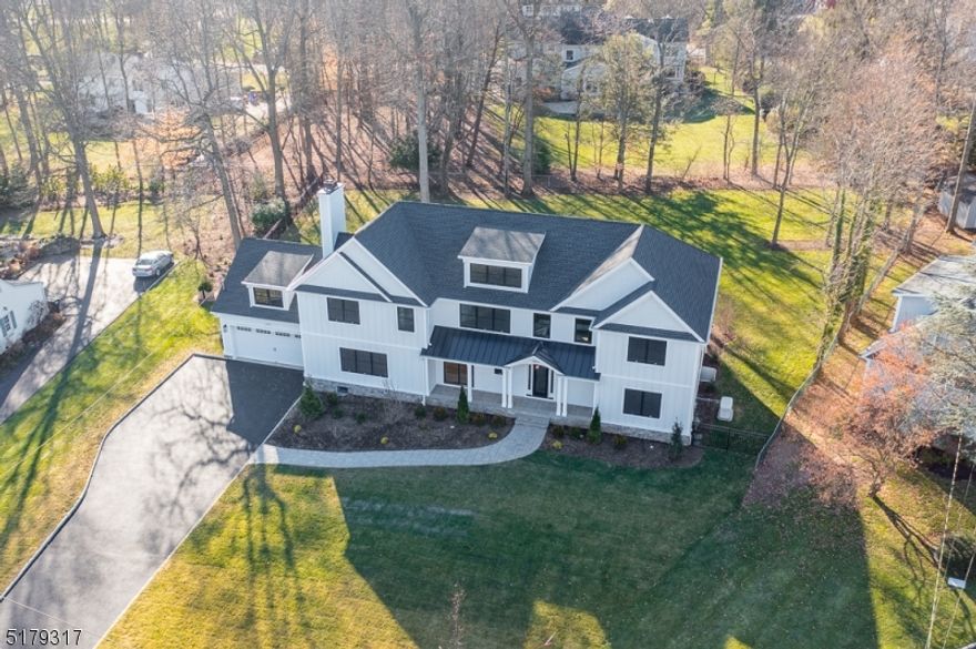 Welcome to this specatucular seven bedroom custom home situated on a sprawling level lot on a cul de sac on the south side of Scotch Plains!  Greeted with a bluestone front porch, enter in the oversized two story foyer w/ herringbone white oak floors, a chef's kitchen featuring high end appliances (Thermador), approx 9 foot wood island, a separate dinette area w/ a sliding door open to the covered porch. Family room open to kitchen features double doors out to the backyard & a custom stone 42 " gas fireplace.  First floor holds a bedroom en-suite and a second bedroom or home office. Powder room features marble floors with a wood vanity to meet the standards of today's most contemporary style. Oversized Anderson 400 series black windows w several paneled doors on the first floor flood this home  with natural light throughout. Second level holds 4 bedrooms-ALL EN-SUITE. Primary bedroom with custom moldings, vaulted ceilings, his/her primary closets with center island & outfitted throughout. Primary bathroom w/ heated floors, a double vanity, oversized tiled shower and a beautiful soaking tub for ultimate relaxation. Lower level includes a bedroom with a full bath, a custom built in bar with quartz countertops & a sprawling open space for recreation. The backyard features a 750 sq foot patio with an outdoor stone fireplace, an outdoor BBQ with full bar covered w/ granite countertops.  FULL home generator. Luxury living at its finest! Please see virtual tour.