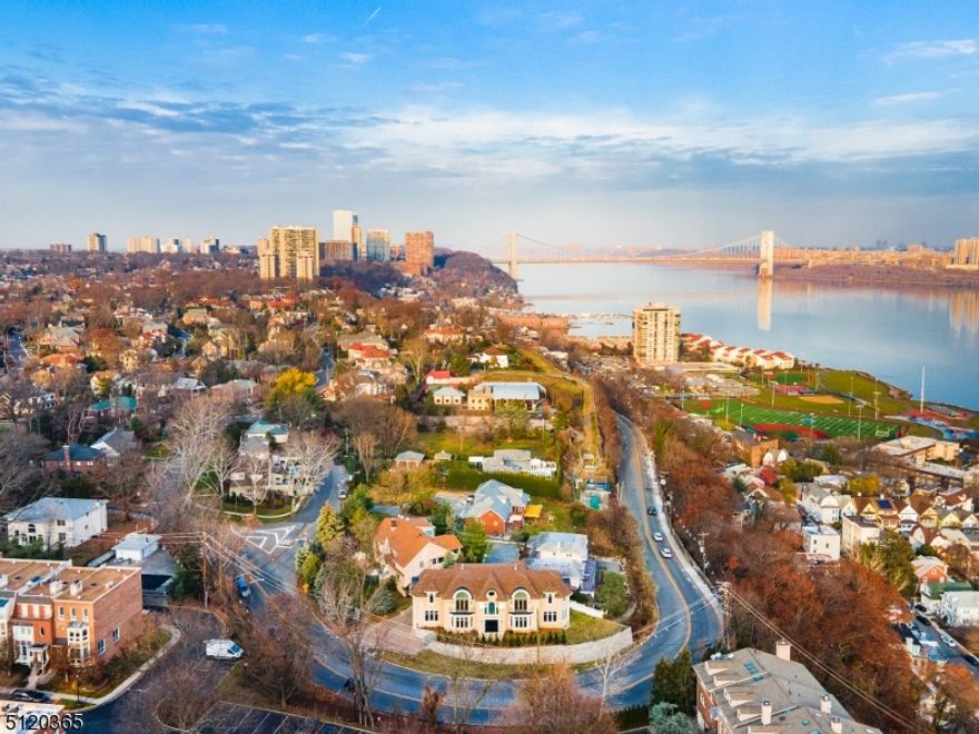 Indulge in the luxurious elegance of this custom-built center hall colonial in the sought-after Bluff section of Fort Lee w/ breathtaking views of NYC. With 5317 sq ft of exquisite craftsmanship this home is a testament to the work of old-world artisans combined w/ today's sophisticated techniques. A blend of traditional& modern styles, desirable amenities, custom moldings& high ceilings. Enter the 2-story foyer w/ double staircase& appreciate the hardwood flr LR&DR, den w/ mahogany inlays& sunlit great rm w/ exquisite architectural details. Gourmet kit features custom cabinets, SS appliances, island, pantry& heated floors like the foyer. Primary BR suite is a haven of tranquility w/ NYC views, luxurious Pr. bath w/ soaking tub, abundant walk-in closet. 4 additional sunlit ensuites w/ high ceilings& laundry rm complete upper lev. Fully finished basement is an entertainer's delight- BR, full bath, exercise rm, entertainment rm, storage. Elevator space has been made for easy installation!