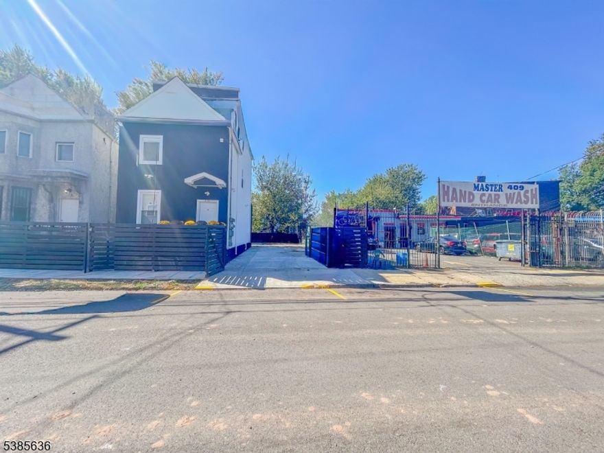 Welcome to this fully renovated two-family home set on an oversized double lot, designed for modern living and complete with a spaciously paved yard and parking for up to 8 cars. Unit 1 (first floor and basement) features 4 bedrooms and 2 full baths, including a main level with 2 bedrooms, a full bath, updated kitchen, living room, washer/dryer, and private balcony. The finished basement adds 2 bedrooms, 1 full bath, and ample closet space. Unit 2 (second and third floors) offers 4 bedrooms and 3 full baths. The second floor includes 2 bedrooms, 1 bath, an eat-in kitchen, and washer/dryer. The third floor Boasts 2 spacious primary bedrooms, each with its own en-suite bath and generous closets. ideal for investors, this property is move-in ready and located close to places of worship, shopping, and major highways.