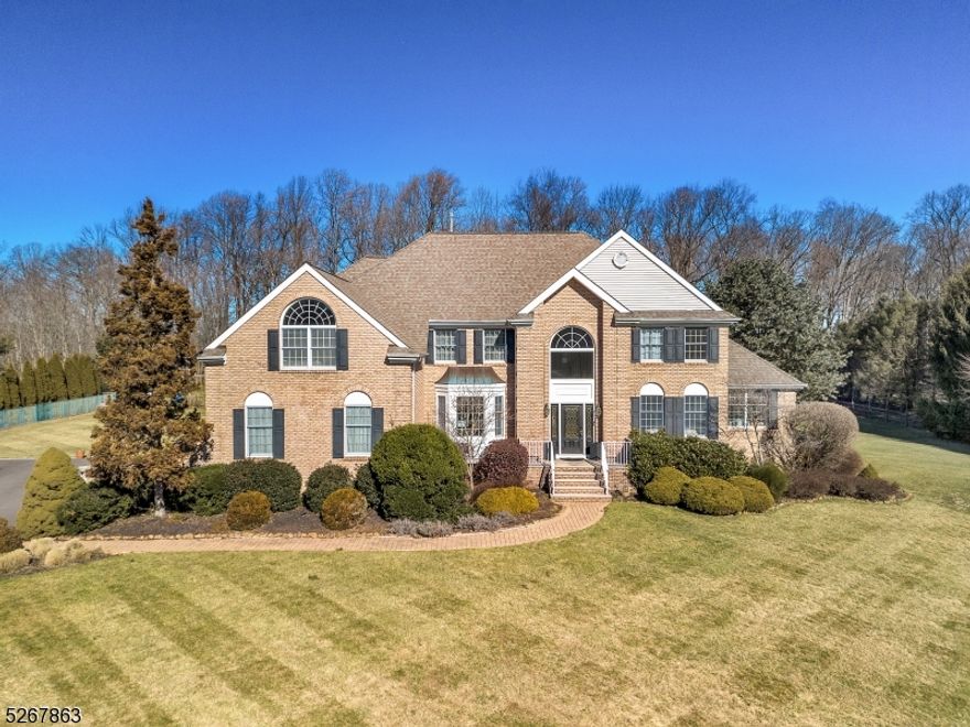 This four bedroom residence sits proudly on two sprawling ac. This stunning well-maintained colonial offers a blend of luxury and tranquility. As you approach the property, a sense of elegance emanates from the meticulous grounds to a grand entrance. The brick front exudes charm harmonizing with the natural surroundings. The expansive back yard  is a haven of relaxation where a saltwater gunite pool takes center stage. Hardwood floors grace the main level creating a warm and inviting ambiance thruout. The open floor plan seamlessly connects the family room, kitchen and dning room, fostering an ideal environment for both entertaining and everyday living.The upper level houses four well-appointed bedrooms with two additional bonus rooms each offering ample space.There are two additional full baths as well.  The primary suite with its double door entry is a sanctuary of comfort, featuring a spa-like ensuite bath.  Venture downstairs to discover the fully finished lower level, perfect for entertainment enthusiasts. Watch the big screen in the home Theater. Practicality meets luxury with the inclusion of a 3 car garage ensuring ample space for vehicles and additional storage.