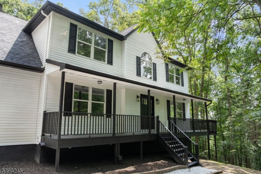 A Modern Estate Like No Other!  Nearly 8 Acres of Total Privacy. Welcome to 51 Pidgeon Hill Rd, a rare modern retreat set at the end of a brand-new private driveway and surrounded by 7.82 wooded acres. Fully renovated from top to bottom, this 4-bedroom, 2.5-bath home blends elevated design, striking architecture, and complete seclusion   a combination nearly impossible to find in Sussex County.The bold black-and-white exterior, expansive decking, and serene natural backdrop set the tone from the moment you arrive. Inside, sleek modern finishes flow throughout. The main level offers a bright living and dining area and a warm family room centered around a stone fireplace. The statement kitchen impresses with stainless steel appliances, quartz countertops, custom backsplash, and abundant cabinetry. A stylish half bath and garage access complete the first floor. Upstairs, all four bedrooms are generously sized. The luxurious primary suite features a walk-in closet and spa-like bath with floor-to-ceiling tile, oversized glass shower, soaking tub, and dual vanity. The finished lower level adds flexible space for entertaining, a gym, media room, or private retreat.This property stands apart with its rare combination of modern design and unmatched privacy. Modern. Private. Architectural. Irreplaceable. Don't miss your chance to own one of Sussex County's most unique homes. Schedule your private showing today.