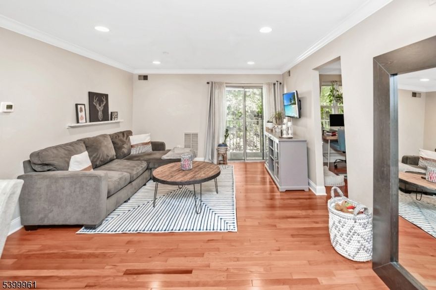 IMMACULATE! One floor condo in desirable Season's Glen community. Elegant hardwood floors, crown moldings, and recessed.  Open living/dining area with sliders to a private deck/ balcony overlooking private wooded views. Eat-in Kitchen with updated appliances. Primary suite high ceilings, walk-in closet, and a full bath. Second bedroom includes wood floors, generous closet space, Just a few mins to bus, train, freeways and awesome community amenities: pool, tennis, playgrounds, gym, clubhouse Must see this place!