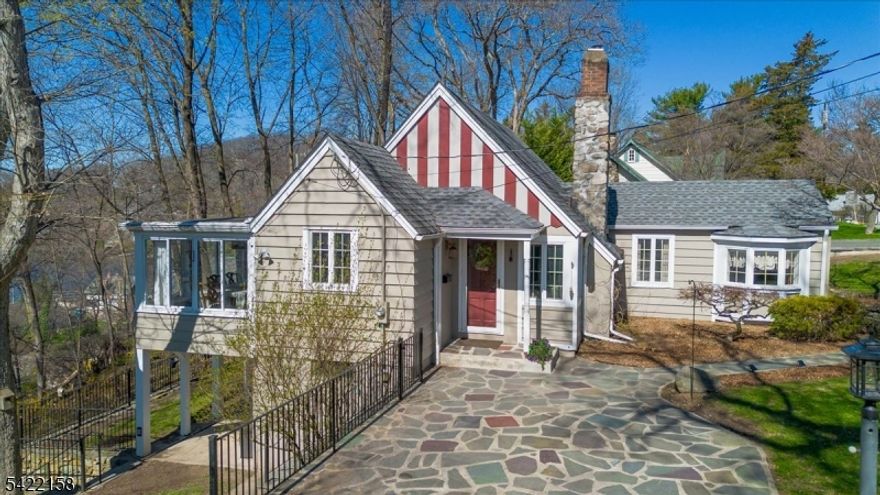 Lake Mohawk Gem! This original Arthur Crane 3-BR, 1.5-bath home features seasonal lake views and an unbeatable location just a short walk to the country club, beaches, and local dining. Inside, the home's kitchen and main bath are beautifully updated, perfectly complementing its classic architectural details. HW floors run throughout, while vaulted ceilings create an open, airy feel filled with natural light. A stunning stone fireplace anchors the living space, adding warmth and rustic charm. A versatile loft enhances the home's unique architecture and can easily serve as a guest bedroom or private office. A walkout basement provides additional flexible living or recreation space, complete with laundry room, workroom, and storage. Outside, the terraced yard offers multiple outdoor entertaining areas, ideal for gatherings, relaxing, or simply enjoying the peaceful surroundings. The property also includes private parking for 3 cars--a premium in LM! Vacation where you live in this tranquil lake community--between the water and the town surrounding it, there's plenty to do in LM. Start your day swimming or enjoying the view on a boat or kayak--back on land, take a walk/jog on the bridal path and head to the boardwalk. Enjoy a delicious meal at the country club, or any of the other restaurants on the plaza. Lake Mohawk Pool, Golf and Tennis clubs are optional. Natural gas & public water. SQFT per tax records.