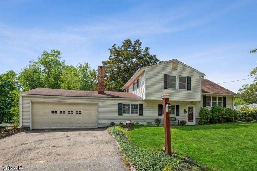 Quiet, peaceful, and room to move! Spacious Split-Level home offers four bedrooms, two full bathrooms, an attached two-car garage, and an expansive fenced-in back yard. Situated in the center of Morris County between Routes 80 and 46, this home is close to shopping malls, restaurants, movie theaters, parks, schools, and grocery stores. Hardwood floors gleam across the bright, open layout in the main level living room and dining room. The open flow continues into the kitchen with ample cabinet and counter space and a breakfast bar. On the ground-level, the family room features a cozy wood-burning fireplace set into a brick wall with an alcove for storing logs and a rustic wood beam mantel. This level includes the primary bedroom, a full bathroom, and an outside entrance to the large patio next to a mature shade tree to keep you cool on the hottest summer days. The upper level has hardwood floors in the three good-sized bedrooms, along with a full updated tile and granite bathroom in the hallway. And to top it all off, a sweeping back yard lawn is fully fenced and offers abundant space for gardening, playing, and relaxing.