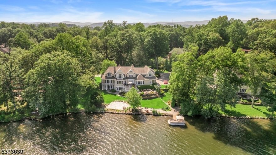 Welcome to this exceptional lakefront home in the highly desirable Pines Lake community. Situated on a beautifully landscaped 0.7-acre lot, this residence offers breathtaking water views, refined interior spaces, and resort-style outdoor living. Elegant two-story foyer with formal living and dining rooms. Stunning gourmet kitchen with center island, high-end appliances, breakfast area, and butlers pantry. Expansive family room with fireplace and walls of windows overlooking the lake. Office/den with a full bath perfect as a guest room or first-floor bedroom option.10-foot ceilings and seamless flow to a large entertaining deck. Grand primary suite featuring two spacious walk-in closets, Spa-like bathroom with radiant heated floors. Four additional Bedrooms, in-suite baths, bonus room/playroom for flexible use. Finished Walk-Out Lower Level: Home theater/media room. Game room/recreation area. Full gym room. Guest bedroom with full bath. Direct access to the patio and private lakefront yard. Outdoor Oasis: Private dock, patio by the water, and multiple balconies and decks. Lush professional landscaping and a tranquil setting. Radiant heat in both the primary bathroom and the lower level for added comfort. Pines Lake Community Lifestyle: Enjoy Lake Life with/ vacation every day. Enjoy year-round access to boating, swimming, kayaking, paddle boarding, fishing, sailing, and vibrant community events like movie nights and summer programs.