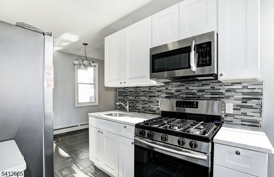 Welcome to this beautifully renovated first-floor unit featuring 3 bedrooms and 1 full bathroom. The updated kitchen is equipped with stainless steel appliances, offering a modern and functional space for everyday living. And the convenience of an in-unit washer and dryer.