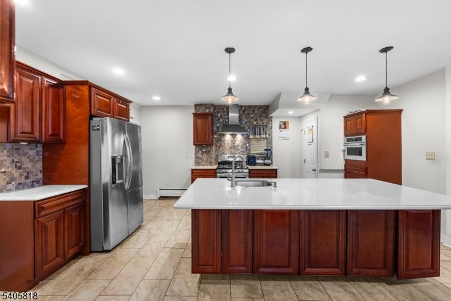 Welcome to 130 Renner Ave the perfect blend of affordability and luxury combined. As you enter, you're welcomed into a cozy living room with a brick fireplace that flows into an open concept kitchen. The kitchen features an oversized Quartz Island, Stainless Steel Appliances including microwave and range, a wine fridge, and a convenient half bath on the main level The second floor offers two bedrooms and two full bathrooms. Head up to the third floor where you'll find the primary bedroom with its own half bath, creating a private retreat. The basement includes a washer, dryer, and plenty of storage space. PLUS, enjoy peace of mind with a BRAND NEW BOILER & FURNACE.