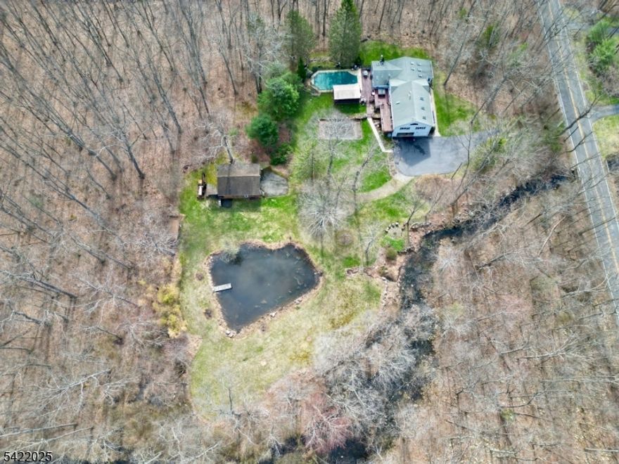 Does your dream home include a picturesque pond, stream and large barn? Would an enormous primary suite with a sunny office, full bath, soaring ceilings and lots of natural light be ideal? What about privacy and proximity to state and federal land? YOU CAN HAVE IT ALL in this rambling 4 bedroom, 3 full bath home set on three acres. Thoughtfully added onto over time, this home is full of character and possibilities. A stunning sunroom serves as a perfect retreat in all kinds of weather. The well equipped kitchen is open to the family room and dining room, each with a wood stove for cozy nights in. The living room boasts high ceilings and a gas fireplace set in beautiful stonework, surrounded by built in shelving. Perfect for entertaining, an in-ground pool is accompanied by a screened-in party room with electric and plenty of room to eat, lounge and enjoy. The multi level deck with hot tub offers direct convenient access to a full spa-style bath. The two car attached garage and large pole barn suit many needs. A blue stone patio, set next to the stream, invites you to enjoy all that nature has to offer. Finished basement rooms offer many possibilities for hobbies, storage and more. Lots of potential exists to convert a section of the home into an in-law suite with its own entrance. A true retreat away from the hustle and bustle of the world awaits you. Near to fishing, hiking and all that country living has to offer. Welcome home!