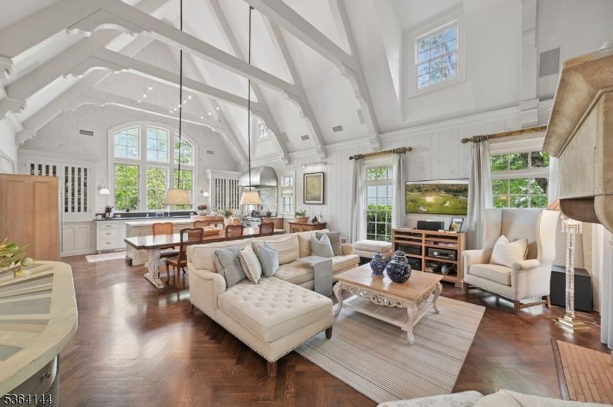 This spectacular one-of-a-kind custom home originally designed and owned by renowned designer, Frank DelleDonne, is nestled on very private grounds with a pool, in Northside Summit.  A DRAMATIC CURVED staircase with many windows and open concept living features a STUNNING Kitchen/Great Room with soaring 24' ceiling, striking beams, amazing fireplace, truly a phenomenal gathering and entertaining space. The primary bedroom suite is located on the first floor, offering a fabulous primary bathroom, walk-in closet, tub and separate stall shower. The other 3 generous sized bedrooms and 2 full bathrooms are located on the second floor, one with bath en suite. Each and every room has special details-very high ceilings, beams, exposed brick, soaring ceilings in some rooms as well, paneled library, wonderful living room w/fireplace... refined, sophisticated and polished. The exterior is stone, stucco and wood and the property offers ultimate privacy...vine covered pergola over the large rear patio, wonderful pool and a front blue stone patio as well. The lower level is completely finished with a rec room, full bathroom,  plus a sunken large area, currently used as an office, and mud room, Entrance to the over-sized garage which can fit 4 cars from lower level. This is a must see home !