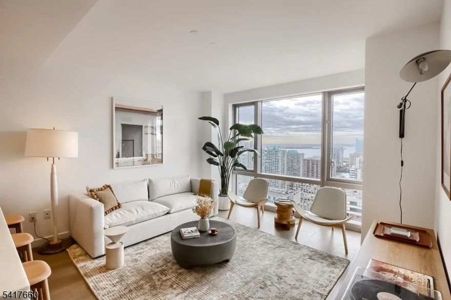 NO HOA PAYMENTS UNTIL APPROX AUG 2027 for this Unit. Timeless luxury waterfront living at 75 Park Lane. Unit 3305 is a stunning one-bedroom, one-bath residence offering sweeping views of the Hudson River and the Lower Manhattan skyline. With southern exposure and abundant natural light throughout, this sundrenched home features a chef's kitchen with quartzite countertops and a premium Bosch appliance package, a spacious living room ideal for entertaining, and a generously sized bedroom complete with a walk-in closet. Automated blinds. Homeowner has prepaid the HOA until approx August 2027, passing this benefit onto the new homeowner!Located in the heart of Jersey City's vibrant Newport neighborhood and surrounded by the lush Hudson River waterfront parks, 75 Park is a premier 37-story luxury building. Perfectly positioned between two PATH stations, the building provides easy access to Manhattan while delivering a peaceful waterfront lifestyle.Residents enjoy resort-style amenities including an indoor heated lap pool, state-of-the-art fitness center with yoga studio, and a teak-lined spa featuring steam rooms. Additional spaces include a wine tasting lounge with private dining room, co-working spaces and conference rooms, multimedia lounge, and a sixth-floor putting green overlooking NYC . The landscaped rooftop sky lounge offers skyline views along w outdoor dining areas & a full prep kitchen. In-unit washer/dryer, central A/C, smart home features including keyless entry.