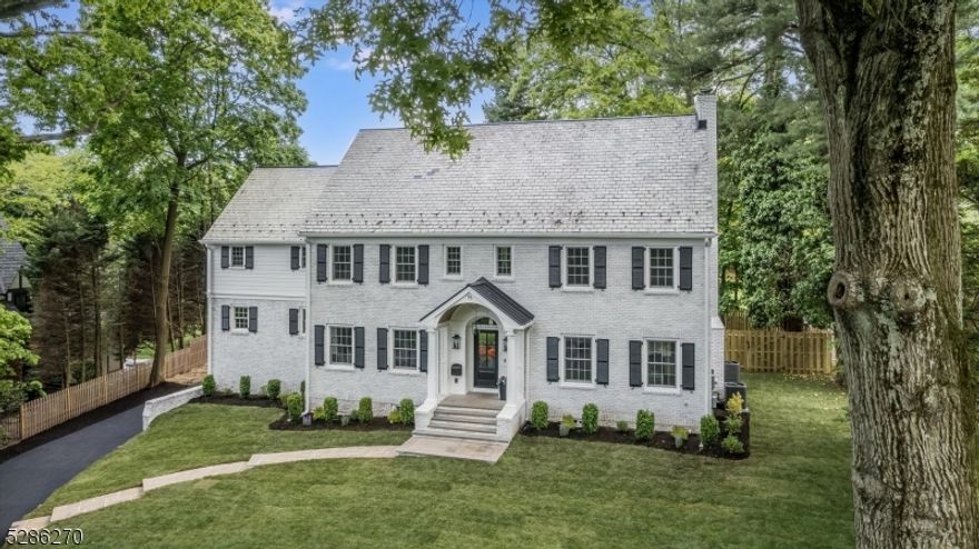 We are thrilled to present this estate section beauty which has been artfully designed and thoughtfully renovated with the utmost consideration of the past and the present. Classic, timeless, architectural detail, sophisticated finishes and modern comfort embrace this center hall colonial filled with formal and informal spaces. A gracious foyer and beautiful stairway greet you upon entry and the first floor flow is perfection with a sunken large living room with coffered ceiling detail, wood burning fireplace and French doors leading to the bluestone patio. The formal dining room boasts a wet bar, wine fridge, dishwasher and quartz  countertops. The kitchen is a show stopper and chef's dream combining function and style w/ herringbone wood flooring, 6 burner Wolf range, custom cabinetry w/ toe kick lighting, Viking refrigerator and double ovens, pot filler, super large island w/ quartz countertops, and ample storage. Cozy library with bookshelves and gas fireplace w/ sliders to covered deck, and jewel box wallpapered powder room round out the first floor.The primary bedroom includes a luxe dressing room and sophisticated primary bath w/ soaking tub, dual vanities and radiant heat floor. 3 addl bedrooms,1w/ balcony,1 w/ ensuite bath plus hall bath and laundry rm w/ new GE washer and dryer. Attached garage leads to mudroom, basement rec rm w/ wet bar, office/gym and full bath. Stunning fenced private property and so close to vibrant downtown Montclair and NYC transportation.