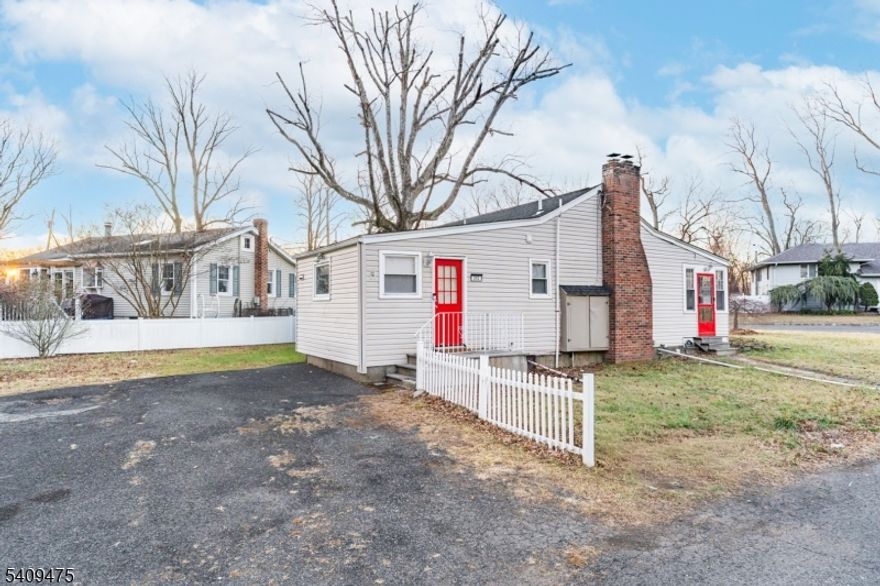 Welcome to a charming 3-bedroom home on a spacious corner lot in Wayne. This move-in-ready residence features a cozy living room with a classic brick fireplace and modern LED lighting. The bright kitchen offers ample cabinetry and a functional island, leading to a sun-drenched enclosed porch perfect for a home office or relaxation. Highlights include an updated bathroom with contemporary fixtures, neutral tones throughout, and a large primary bedroom. The property boasts a massive driveway and an expansive yard for outdoor enjoyment. Ideally located near local shopping, dining, and transit, this home offers comfort and convenience in a prime location.