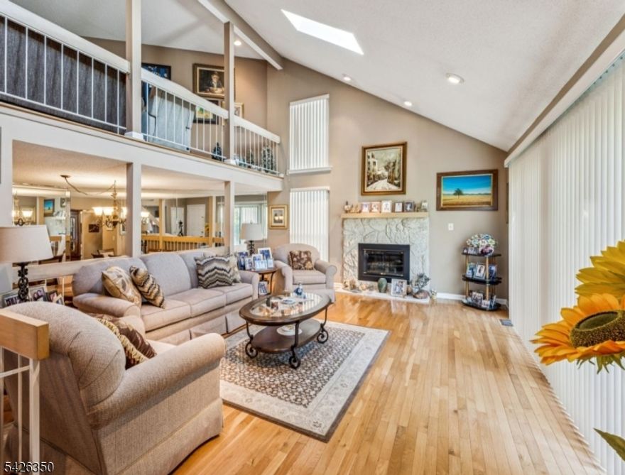 Stunning townhouse located in the highly desirable Westgate Square II of North Edison! Prime location set on a premium lot offering spectacular wooded views. This home features a spacious living room with gas fireplace, cathedral ceilings and skylights, along with newer, elegant wood flooring throughout. The updated kitchen includes a newer stove, and additional upgrades include a new dryer, some newer interior doors, and roof. The water heater and furnace are approximately 5 years old. A master bath with shower adds comfort and convenience. Additional highlights include a fully finished basement-perfect for additional living space or recreation-and a versatile loft with built-ins, ideal for a home office, den or library. A slop sink is also located in the garage for added functionality. Top rated North Edison Schools, and easy access to school bus stops. Community amenities include: swimming pool, tennis court, and playground. Enjoy the convenience of this home which comes fully furnished!