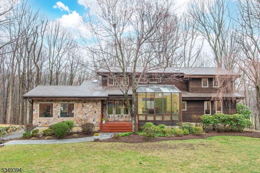 Welcome to this one-of-a-kind, custom-built Lindal Cedar Home, where architectural design meets natural beauty. Nestled on nearly 3 acres of private, wooded lot, this Post & Beam construction home is a masterpiece of craftsmanship & sustainability. Designed with large expanses of windows, the home brings the outside in, offering panoramic views that stretch across the lush landscape. The open floor plan & soaring ceilings create a sense of spaciousness, perfect for both relaxation and entertaining. As you step into the large glass-enclosed foyer, you're immediately welcomed by a breathtaking two-story stone fireplace in the living room that adds a dramatic focal point.On the main level, you'll also find a luxurious primary suite w/ 2 walk-in closets & a newly renovated (2020) spa-like bath w/ heated floors. The 2nd floor offers 3 spacious bedrooms, a full bath & balcony that overlooks the living room below.The Bright walk-out basement has potential for an in-law suite w/ large windows, a full bath, and closet space.Lovingly cared for by the current (2nd) owner, other recent updates include: New ROOF & Skylights 2024, NEW Front Walkway 2024, Newly Lined POND 2024, Basement mini-split 2022, 2nd floor furnace 2023. And a Lutron Caseta home automated system. Shongum Lake Community offers access to a clubhouse, beach, boating, swimming, and a full calendar of social events.