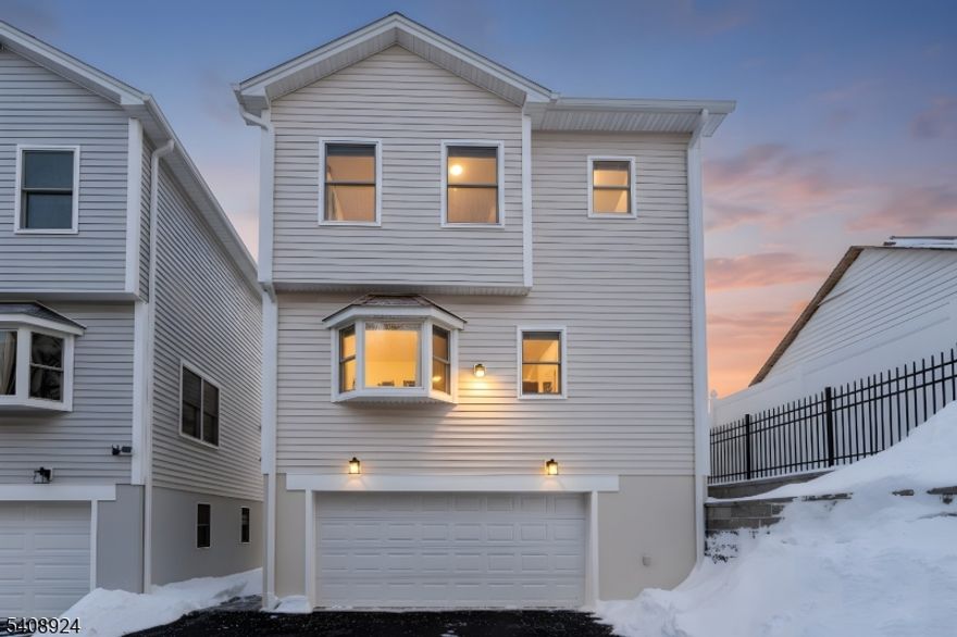 Welcome to The Estates at 5th Avenue, where modern luxury meets smart affordability in this brand new 2025 construction designed for comfort, efficiency, and elevated living. Step inside to discover 9-foot ceilings with elegant crown molding, rich hardwood flooring throughout, and recessed lighting that creates a warm, upscale atmosphere on every level. The thoughtfully designed layout offers 2 spacious bedrooms and 2.5 bathrooms, including private suites with walk-in closets and baths featuring premium Kohler and TOTO finishes. The heart of the home is the beautifully appointed 10 12 kitchen, complete with a sizable pantry and high-end Whirlpool appliances perfect for both everyday living and entertaining. Pre-installed TV hookups, a dedicated laundry room, and abundant closet space add everyday convenience. Comfort is effortless with central HVAC and 3-zone climate control, allowing you to customize temperatures on each level. A security system, covered porch, and 2-car garage enhance both privacy and peace of mind. One of the standout advantages? A 30-year tax abatement, keeping ownership costs significantly lower. The low $150/month HOA covers exterior maintenance, landscaping, irrigation, snow removal, lighting, and more giving you a low-maintenance lifestyle. Located with direct public transportation to NYC, Hoboken, and Jersey City, and close to schools, dining, and shopping. Luxury. Efficiency. Value. Make this exceptional opportunity yours before it's gone.