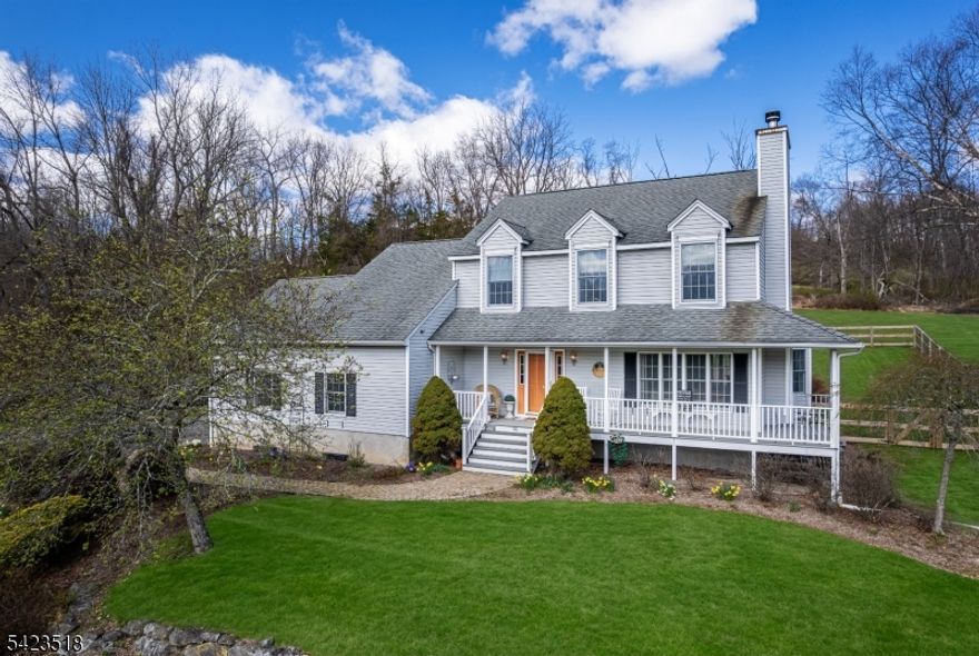 Fall in love every time you arrive home to breathtaking, picture-perfect views. This 4-bedroom, 2.5-bath colonial rests on 3 acres of serene countryside. Unwind on the wraparound covered porch and soak in the beauty all around. Inside, a warm and inviting foyer welcomes you, leading to a bright first floor filled with windows that bring in natural light and frame the stunning scenery. The living room offers a shiplap accent wall and a cozy wood-burning fireplace, while the dining area features a wall of windows. The open kitchen includes a center island and a breakfast nook with seating. A pantry/coffee bar room. The family room's sliders open to the fenced yard, complete with a paver patio and fire pit for endless relaxation or entertainment. Upstairs, all bedrooms are located along with a spacious main bath featuring double sinks. The master suite boasts a tray ceiling, shiplap accent wall, closet, and a luxurious bath with a jetted tub and separate shower. The full unfinished basement is ready for your personal touch, whether for entertaining or a home gym, and includes a wood-burning stove for extra. An above-ground oil tank and 2-car garage with openers complete the package. Make this charming house your home!