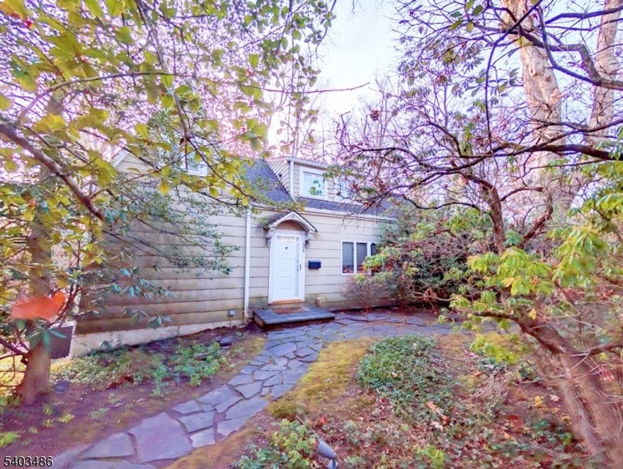 Located in Short Hills and within the highly desirable Deerfield Elementary School district, this charming 3-bedroom, 2-bath home offers exceptional convenience just a short walk to the Millburn train station with service to Midtown Manhattan, downtown Millburn, and top-ranked Millburn Middle School. Inside, you'll find hardwood floors, an updated kitchen, and a convenient first-floor primary bedroom with an updated en-suite bath and extra closet space. The living and dining rooms showcase beautiful backyard views, while three additional bedrooms and a full bath are located upstairs. The walkout basement includes a full-size laundry area, abundant storage, access to the attached garage, and direct access to the backyard patio. Outside, enjoy a serene yard with a running stream, great privacy, and easy access to the scenic trails of South Mountain Reservation.