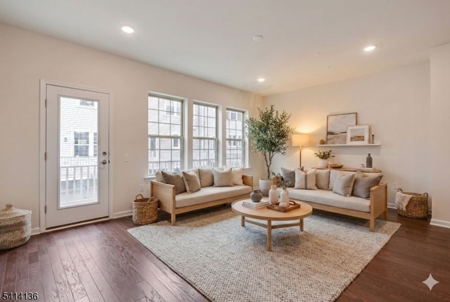 Spacious and beautifully designed, this 4-bedroom, 3.1-bath townhome in the sought-after Livingston Square community offers three levels of modern living with 9-foot ceilings throughout. Set on a quiet cul-de-sac within the community, this home combines style, comfort, and a flexible layout ideal for today's lifestyle. The entry level features a private bedroom and full bath with direct access to the two-car garage, creating the perfect setup for guests, a home office, or additional living space. Upgraded hardwood staircases lead to the main level, where an open living and dining layout flows seamlessly into a gourmet eat-in kitchen with quartz countertops, stainless steel appliances, a large center island, and two full-sized pantries for exceptional storage. Sliding doors open to a maintenance-free deck, extending the living space outdoors. A powder room and separate office nook complete this level. Upstairs, the primary suite offers a tray ceiling, dual walk-in closets, and a spa-like bath with double vanities and an oversized glass-enclosed shower. Two additional bedrooms, a full hall bath, and upper-level laundry complete the top floor. With its quiet cul-de-sac setting, generous proportions, and easy, functional layout, this home offers a polished rental opportunity in one of Livingston Square's most desirable pockets.