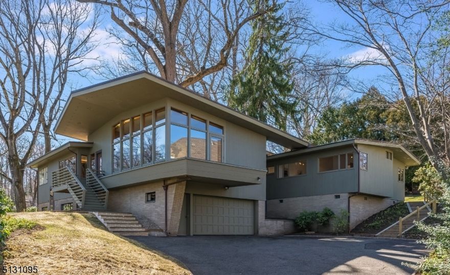 The original owner of this Mid-Century Masterpiece, located in the heart of the exclusive Northside of Summit, used his own lumber company to pick the rarest of woods, the finest craftsmanship available and the highest custom detailing of its kind to mimic an original Frank Lloyd Wright bespoke home. This circa 1950s home boasts 12 rooms, 6 bedrooms, and 3.2 sparkling  baths to match the glistening Chef's kitchen. Enjoy the NYC views as you enjoy the endless entertainment spaces which lead out to multiple terraces and almost an acre of mature grounds. Speaking of entertaining, this quintessential "Mad Man" home comes with a hidden martini bar, cove lighting, and a California wall of glass that brings the outside in! Perfect for a Samba Line or dancing to the crooning voices of the Rat Pack. Included in the sale of this home is the property at 36 Glendale Road, a 54 x 150 separate conforming lot. Come live the life of the 50s but enjoy all the amenities of this decade with plenty of outdoor space.