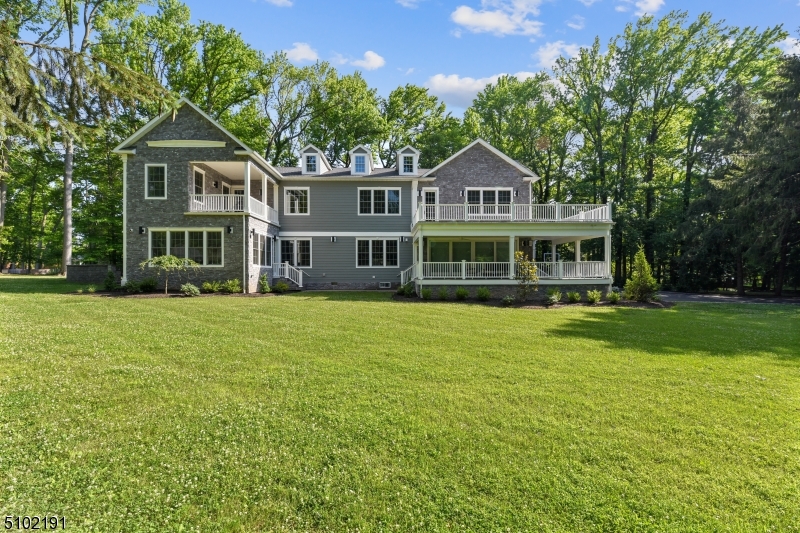 Move right into this beautiful NEW construction with custom designer finishes.  Home sits on almost an acre of land with a beautiful wraparound porch with top of the line appliances and electronics. 1st floor has an open concept floor plan with a designer kitchen and an Island that accommodates 6 people.  A Butler's pantry allows additional storage space. Formal Livingroom, dining room, sunroom & breakfast room. The home is drenched with natural sunlight and is perfect for large gatherings. Recessed lighting throughout. Sliding doors gives access to the porch & generous backyard. 2nd floor features 5 bedrooms 2 with ensuites. Massive master bedroom, custom WIC, sitting area, office that leads to a balcony. Hard wood flooring. Three gas fireplaces, thermal windows & many more features.
