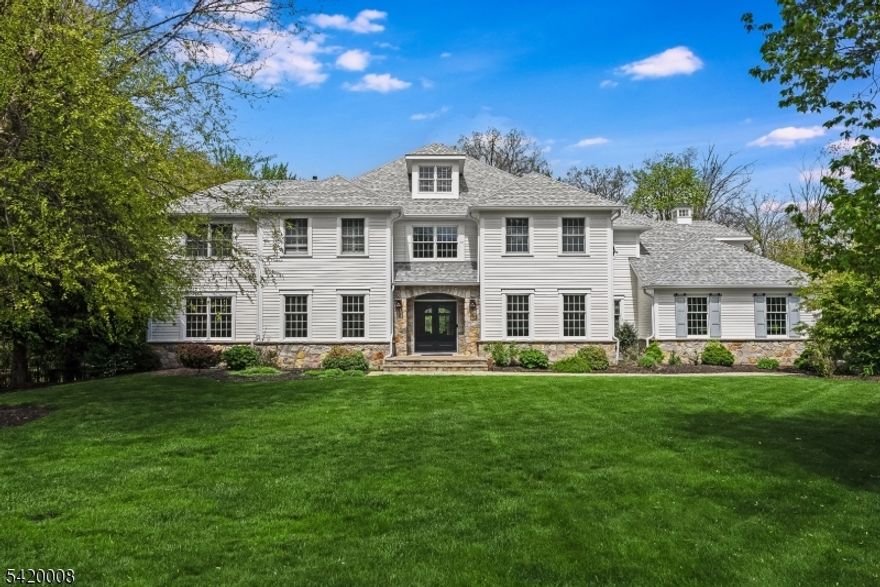 Set on over seven acres of sweeping lawns and private wooded surroundings, this exceptional five bedroom, four full and one half bath residence offers a refined, design-forward aesthetic with resort-style living. Light-filled interiors feature clean lines, curated finishes, and designer lighting. The gourmet kitchen is outfitted with commercial grade appliances, custom cabinetry, and an expansive center island, opening to inviting gathering spaces for everyday living and entertaining. A richly appointed club-style family room with coffered ceiling and stone fireplace adds warmth and character, while marble baths and fresh neutral interiors create a crisp, modern feel. The luxurious primary suite offers a vaulted tray ceiling, two room layout, spa-like bath, and two walk-in closets. The walkout lower level is designed for entertaining and serves as a pool house, with lounge areas, bar space, full bath, fitness room, custom wine cellar, and a flexible fifth bedroom ideal as a guest suite or playroom. Outdoor living features a saltwater pool, expansive decking, and privacy. Recent updates include 2024 roof, front doors, gutters, plus renovated 3 car garage with epoxy floor and lower level in 2022. Truly move-in condition. Located in "The Hills" with access to pool, pickleball, tennis and fitness. Basking Ridge location with award winning schools, easy access to highways, airport, parks, and proximity to golf and equestrian facilities. Four flat screen TVs and built-in speakers.