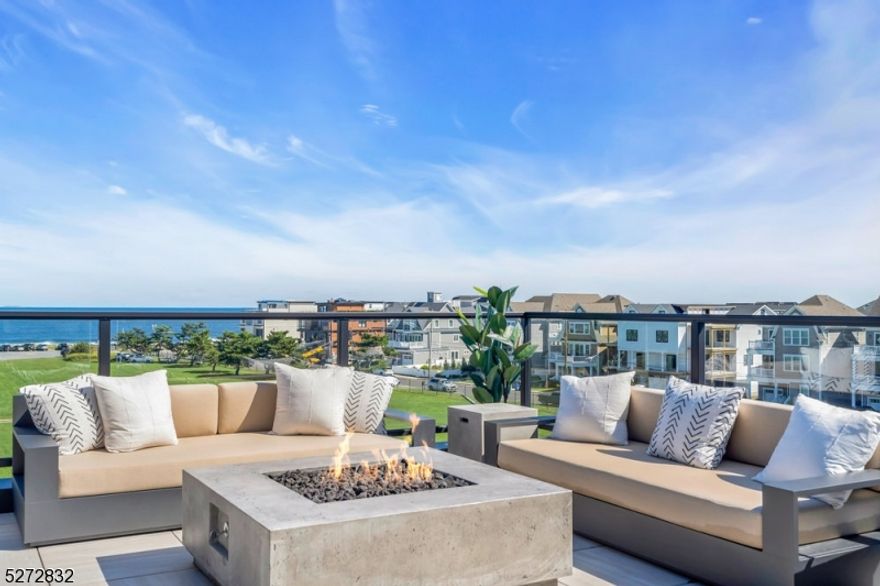 This home is fully ready to be your Summer 2024 beach home! Discover the pinnacle of seaside elegance in this exquisite brand new 5 bedroom, 5 bathroom ocean view townhome nestled in the heart of the beautiful seaside community of Long Branch. The Reef offers the very best of luxurious living with a host of extraordinary features that make it a dream coastal destination. Each residence was meticulously constructed by a renowned local Custom Home Builder with attention to detail and a perfect blend of beautiful design, luxury finishes, & quality craftsmanship. As you enter your home you are greeted by the convenience of a private four-stop elevator. The rooftop deck is nothing short of spectacular, complete with a cozy fire pit and an outdoor kitchen. Here, you can savor sunsets, entertain guests, or simply unwind while soaking in the breathtaking views of the oceanfront. At The Reef, luxury & coastal living merge seamlessly. Two beautiful Gunite Pools, a well-equipped gym & community center are all at your disposal with none of the maintenance! All of this located a short distance from beaches, boardwalk, dining & entertainment at the heart of the Jersey Shore! Don't miss your chance to experience this unparalleled blend of comfort and style. Your Shore Lifestyle is calling!
