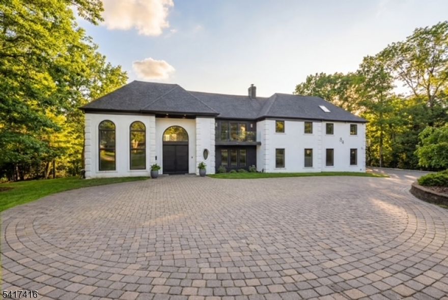 Elegantly designed Contemporary masterpiece showcasing exceptional craftsmanship and impressive scale throughout. A dramatic two-story entry foyer opens to a professionally designed curved glass staircase. Continue onto a soaring two-story living room with cathedral ceilings and an elevator that leads directly up into your 1400 sqft. resort style master suite. Custom moldings and quality hardwood floors enhance the home's refined character. The oversized, state-of-the-art eat-in kitchen is equipped with custom cabinetry, granite countertops, a 20ft. center island with sink, top-of-the-line appliances, a spacious breakfast area, butler's pantry, and built-in glass wine rack. Sliding glass doors lead to a private backyard with deck, ideal for indoor-outdoor entertaining. The expansive finished basement offers a second living space, mother in law suite, laundry room, and walk-out directly to backyard. Meticulous attention to detail throughout. Offering over 10,000 square feet of gracious living space, this exceptional residence is ideally located in the highly desirable neighborhood of Livingston, NJ.