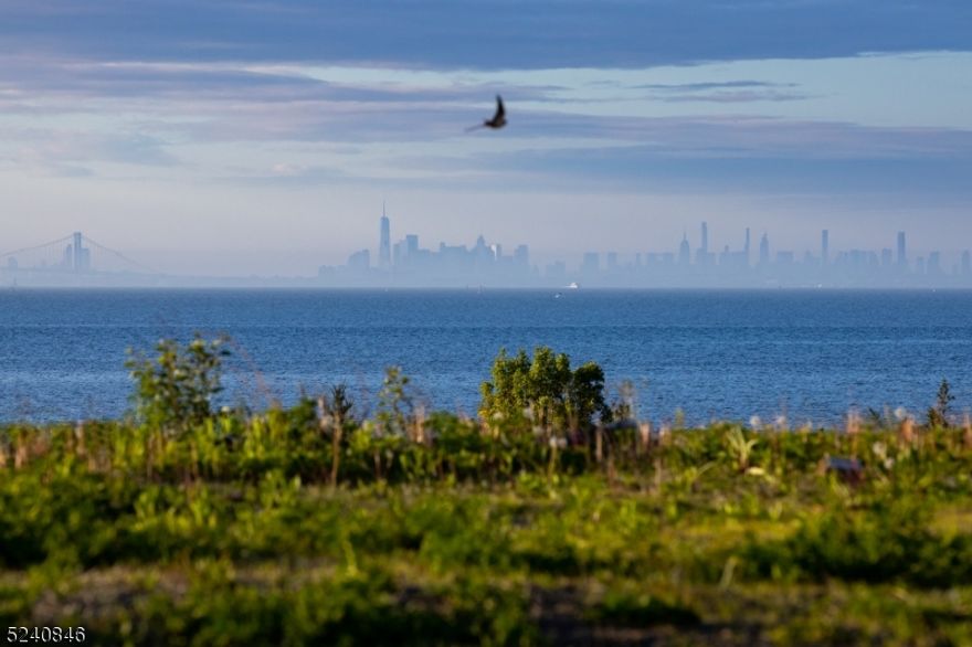 Discover unparalleled luxury! Nantucket inspired four-bedroom homes located on 7 waterfront acres in Atlantic Highlands. Spacious open living floor plans complete with Anderson windows and lift & slide doors to enhance your oceanfront living. Interiors include designer grade kitchens with oak wood flooring, Thermador appliances, Kohler fixtures, spacious laundry rooms, and primary suites equipped with dual walk-in closets. Enjoy expansive ocean views from private decks in each bedroom. All homes have an upgrade option for pool, outdoor shower, and are pre-wired for a generator. Lot 5.14 (refer to site plan) will be nestled on prime waterfront property with one car garage. Right below the community, private access to waterfront walkway with breath-taking ocean views. Pictures are artist renderings only. All colors finishes/dimensions are subject to change without notice. No Elevator option. Located few short blocks from downtown, beach, restaurants, Catamaran Club, Seastreak Ferry