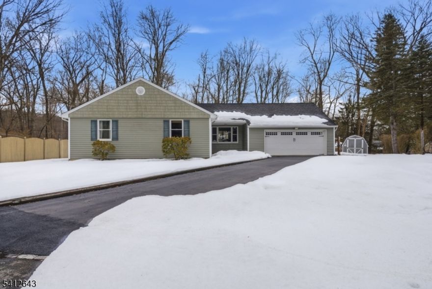 Welcome to 1 Colonial Road in the desirable Lake Telemark section of Rockaway, a beautifully maintained ranch style home set on a quiet one-way street just off Green Pond Road, offering both privacy and convenience. This inviting 3 bedroom, 2 full bath home features a spacious and functional layout perfect for comfortable everyday living and entertaining. The bright formal living room showcases a large picture window that fills the space with natural light, while the formal dining room provides the perfect setting for gatherings. The kitchen offers great flow and accessibility to the main living areas. A separate family room with a cozy wood-burning fireplace creates the ideal space to relax, with sliding glass doors leading to a back patio overlooking the expansive, level backyard. Backing to a wooded area, the property offers peaceful views and added privacy. Additional highlights include an oversized garage, generous driveway parking, and a well-manicured lot with plenty of outdoor space for recreation or entertaining. Enjoy all the benefits of the Lake Telemark community, including lake access, scenic surroundings, and a true neighborhood feel, while remaining close to major roadways, shopping, dining, and everyday conveniences. Don't miss this opportunity to own a move-in ready ranch in one of Rockaway's most sought-after lake communities!
