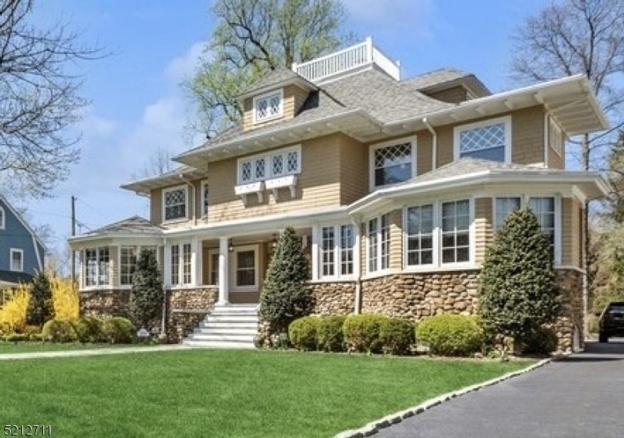 This house is why you move to Montclair! A prime location, this Berkshire-style side hall colonial is located steps from Watchung Plaza & the Mid-town Direct train. Bathed in sunlight, the graceful interiors of this home feature coffered ceilings, original moldings, and wood floors throughout. The 1st floor features a chef's kitchen with a large center island, double ovens, and Miele dishwasher. The open kitchen/family room extends to a wraparound deck overlooking the backyard. A formal living room and paneled dining room with soaring ceilings provide the perfect backdrop for entertaining. Working from home is a pleasure from either of the 2 offices, each featuring three walls of mullioned windows. A half bath, a large laundry and mudroom complete the 1st floor. In the basement, a lounge and custom temp-controlled wine cellar are at your disposal. The 2nd floor includes a primary suite with walk-in California closets, in addition to 2 spacious bedrooms each with their own cozy window seat. On the 3rd floor, a skylit bathroom, a guest room and large playroom offer the perfect space for visitors. The deep half-acre flat yard (ideal for a pool) includes a tree house and a 2-car garage with a finished studio above. This is your forever and ever home.