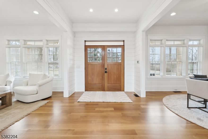 Enjoy a magnificent 2 year old home with 10ft first floor ceilings on 6 acres at the end of a private road. Taxes only $38,857. This McCann-built masterpiece, provides privacy and a convenient location in New Vernon NJ! The thoughfully designed floor plan offers multiple living options, with two primary suites; one on the main floor and one on the second level both featuring sleek linear gas fireplaces. The home also includes several bonus rooms ideal for office and flex space, including one above the 3 car garage with a separate entrance. The stunning kitchen has chef grade appliances, an oversized island, farmhouse sink, and Vikiing range. There is a Wet-Bar in the dining area and in the main floor primary, and the LL. Each of the 7 brs are en-suites including in the LL which is fully finished entertainment space including a wine room, theatre area with a wet kitchenette, a play area and for fitness enthusiasts, a professional grade fitness room with rubber flooring, a wall of mirrors and equipment included. The main level opens to the back deck with beautiful brick pavers, an outdoor kitchen with expansive fenced in yard finished with a beautiful deep blue fiberglass pool. Exquisite millwork ship-lap and distressed wood accent walls finish the interior. 12-15 minutes to Morristown & Summit, outstanding private schools, Morristown airport, NJ Jets training facility, Overlook and Morristown medical centers, trains to NYC, and incredible restaurants.