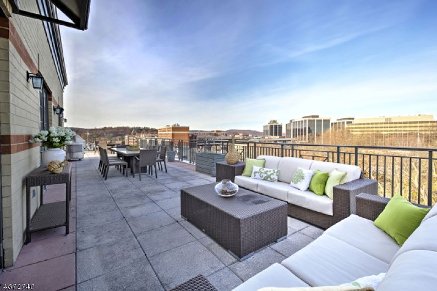 On top of the world! 40 Park's most desirable penthouse- Unit 703-downtown Morristown's premier, one-of-a kind residence offers stunning, panoramic views facing the Green and unparalleled privacy, luxury, and convenience. Prized, top-floor location with 1,800+ sq ft wrap around terrace with private Dehart Street underground assigned parking, discreet piazza courtyard rear entrance, concierge services, exclusive elevator access to 7th floor, and premium amenities including Club Room, fitness center, and full catering kitchen.  7 rooms, 3 bedrooms, spacious den, 3 1/2 baths and brimming with special design features- this home offers a superb 2,780 sq ft open floor plan, including a spectacular 1,820 sq ft wrap around terrace overlooking Morristown skyline. Life at the top doesn't get any better than this!