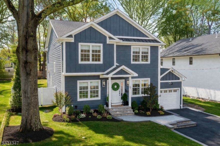 Exceptional curb appeal defines 77 Commonwealth, where a meticulously maintained property and timeless Hardie Plank siding create a striking first impression. This custom-built home offers 3,643 sq. ft. of thoughtfully designed living space, including a finished lower level, with Hunter Douglas window treatments throughout. A welcoming foyer opens to a formal living room or home office and elegant dining room, leading to a designer chef's kitchen with custom cabinetry and hardware, JennAir professional-style appliances, quartz island, and built-in beverage refrigerator. A sun-filled breakfast area flows into the inviting family room with gas fireplace. The main level also features a mudroom with built-ins, pantry, powder room, and garage access. Upstairs offers four spacious bedrooms and a full hall bath. The primary suite includes a double vanity bath, walk-in closet, tray ceiling, and a versatile sitting room - ideal for a home office, Peleton, etc. The finished lower level features a private fifth bedroom with adjoining living area, full bath, and separate rec space ideal for a guest suite. Enjoy a private fenced backyard with deck, plus a whole-house Generac generator, irrigation system, and custom shed. One block to Oakwood Park and close to downtown restaurants and small businesses, transportation, and top-rated schools.