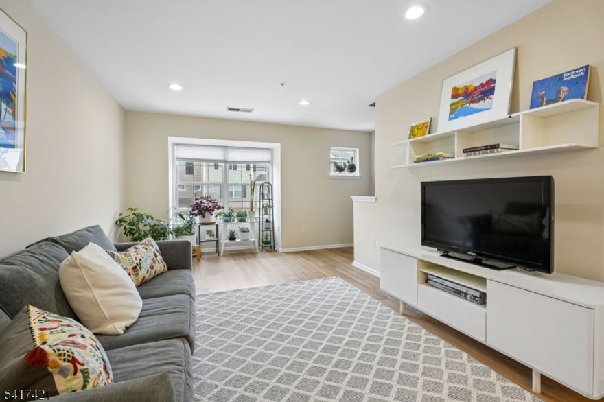 Contemporary, pristinely-maintained 2 bedroom, 2.5 bath condo in desirable Lion Gate community. On the Glen Ridge border and Ideally located next to Lion Gate Park with walking paths, a Tot Lot, soccer fields and a 4-acre fresh water wetland. Open concept, two-floor unit with living room flowing to dining room and new floors throughout. Muted color palette is relaxing and blends with any decor. The sparkling white updated kitchen has an extended countertop that serves as a breakfast bar. All stainless steel appliances, pale wooden floor and so much cabinet/storage space. Kitchen opens to a cozy den with a gas fireplace and sliders to a private balcony. Ensuite Primary Bedroom on 2nd floor is spacious and sun-filled with walk-in closet. Bath includes a marble-topped double sink and separate tub and shower. Laundry also found on 2nd level. Second bedroom with full bath in hall. Attached, ground-level garage means always easy parking, plus plenty of guest parking in the community. Unit also includes a powder room on main floor and large storage space next to garage. Pets allowed.