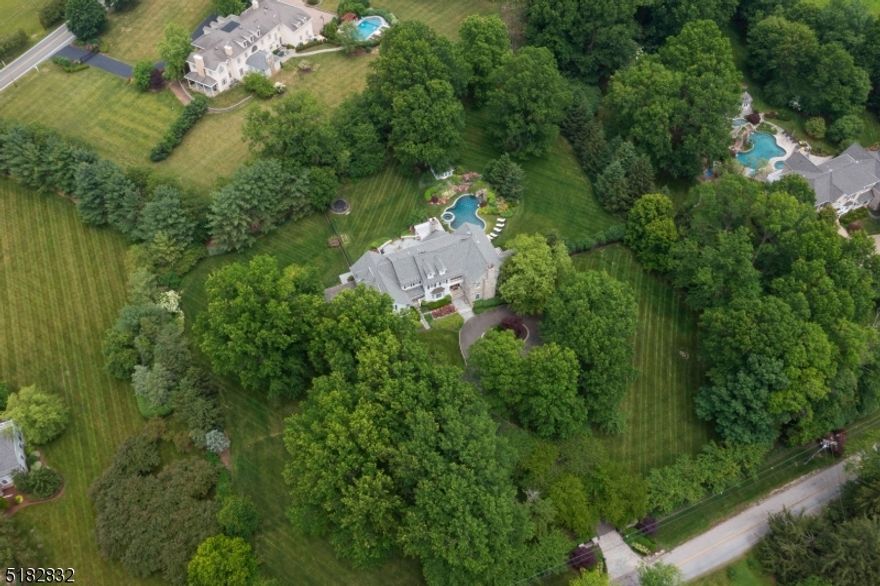 This resort like living center hall colonial home is set up perfectly for the work, play, life balance we are all looking for. 6 beds, 5 full and 3 half bath home is all updated and ready for you to move right in. The first floor welcomes you with a large 2 story foyer that is flanked by a living room and dining room. There is also a 2 story office, a bar/sunroom that overlooks the pool, a large laundry and mudroom as well as a beautiful white kitchen that opens up to the family room. Upstairs you have 5 bedrooms, a play room, laundry room and master suite with fireplace, 2 walk in closets and a spa like bathroom. The basement is finished with a large rec room, gym, game room and office or room that could be used as a bedroom with a full bath-there is also ample storage. There is a walk up 3rd floor attic. The house rests on 3.7 acres and has a sweeping driveway lined with cherry blossoms. When you walk outside the kitchen you step on to a large patio with outdoor kitchen, fireplace, large flat yard and pool with hot tub. This home awaits you to provide you with the best life you can live.