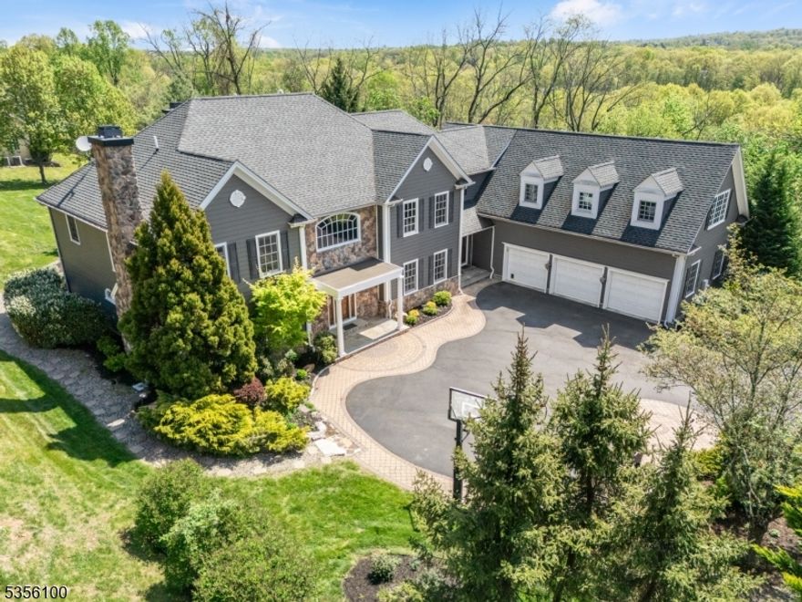 MAJESTIC, MASSIVE, MAGNIFICENT PRIVATE OASIS! Your next best chapter begins at 5 Kincaid Lane, a 4 Bedroom, 4.2 Bath, 9,728 sq.ft home w/ architectural finesse, hardwood floors, tremendous light, & soaring ceilings! Grand 2-story Entry lures you into formal Living Room, boasting crown molding w/ chic cove up-lighting & elegant marble fireplace. Dining Room with charming chair rail molding and wainscoting offers easy access to handsome Butler's Pantry with wet bar and glass-door cabinets. Delight in whipping-up delicious meals in Chef's Kitchen w/ high-end finishes & SS appliances (Viking, Sub-Zero, Bosch). Inviting Center Island w/ pendant lighting, plus glass slider to pristine bluestone patio is a must-have for ideal alfresco living. Family Room is both vast and cozy   a haven for gatherings of all sizes; and monumental stone fireplace is exceptional! Also, French doors lead to private Backyard oasis w/ lovely gardens & fan-favorite Fire Pit. En-Suite Bedroom, Home Office, Powder Room, & Laundry/Mudroom with access to oversized 3-car garage rounds out Level 1. Level 2 Primary Bedroom "Wing  WOWS w/ 2 gigantic walk-in custom closets, spa-like Bath w/ dual marble vanities, jetted tub, & glass door shower. 2 more bright Bedrooms offer awesome closets; plus vast, extensive Recreation Room on this Level can also transform into 2 Bedrooms plus a Rec Room! Lower Level shines w/ gorgeous, custom Wine Cellar, Home Theater, & Exercise Room. Close to shopping, parks, and more!