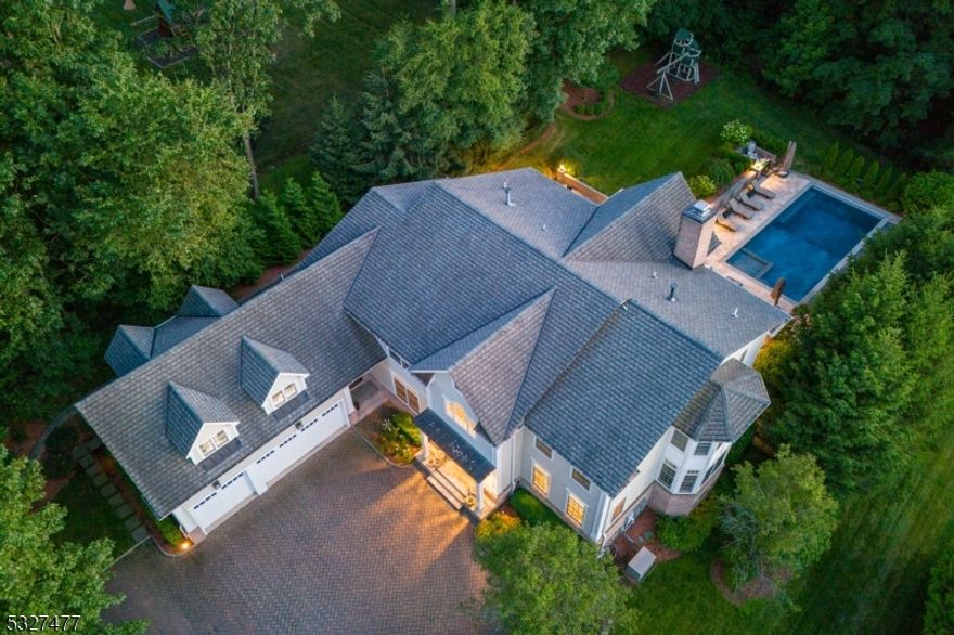 7,800+ SQ FT, STUNNING CUSTOM COLONIAL! Nestled on tree-line street with exceptional craftsmanship and premium smart automation system. Fenced-in Backyard oasis featuring heated, salt-water, chlorinated Pool with electronic cover, blue stone Patio, covered Porch, Playset, exquisite landscaping and custom outdoor lighting. Sun-filled First Level offers Gourmet Kitchen with Wolf and Sub-Zero appliances, easy flow with Control4 blinds and marble Fireplace, Dining Room with custom silk wallpaper, Breakfast Area with French doors to Backyard. Gorgeous inlaid hardwood floors, raised panel wainscoting, built-in shelving and cabinetry, crystal chandeliers, transom windows throughout, and much more! The Primary Bedroom is the ultimate retreat with built-in Miele coffee maker and beverage fridge, two California closets, and en-suite Bath with jetted soaking tub and marble floors. All other Bedrooms are en-suite with large closets, including a new custom-built Bunk Room. Convenient Second Level Laundry. Impressive Lower Level with Control4 light, sound, and video smart home automation, media room with 115-inch screen, 1,000 bottle, temperature-controlled Wine Cellar, Home Gym with rubber floors, Kitchenette with custom cabinetry, glass shelving, seating, and silver-infused tile backsplash. Whole-home Kohler Generator, outdoor Wi-fi, 5-zone AC/heat, and Water Softener System are just some upgrades. Come experience elevated living at 20 Candace Ln!